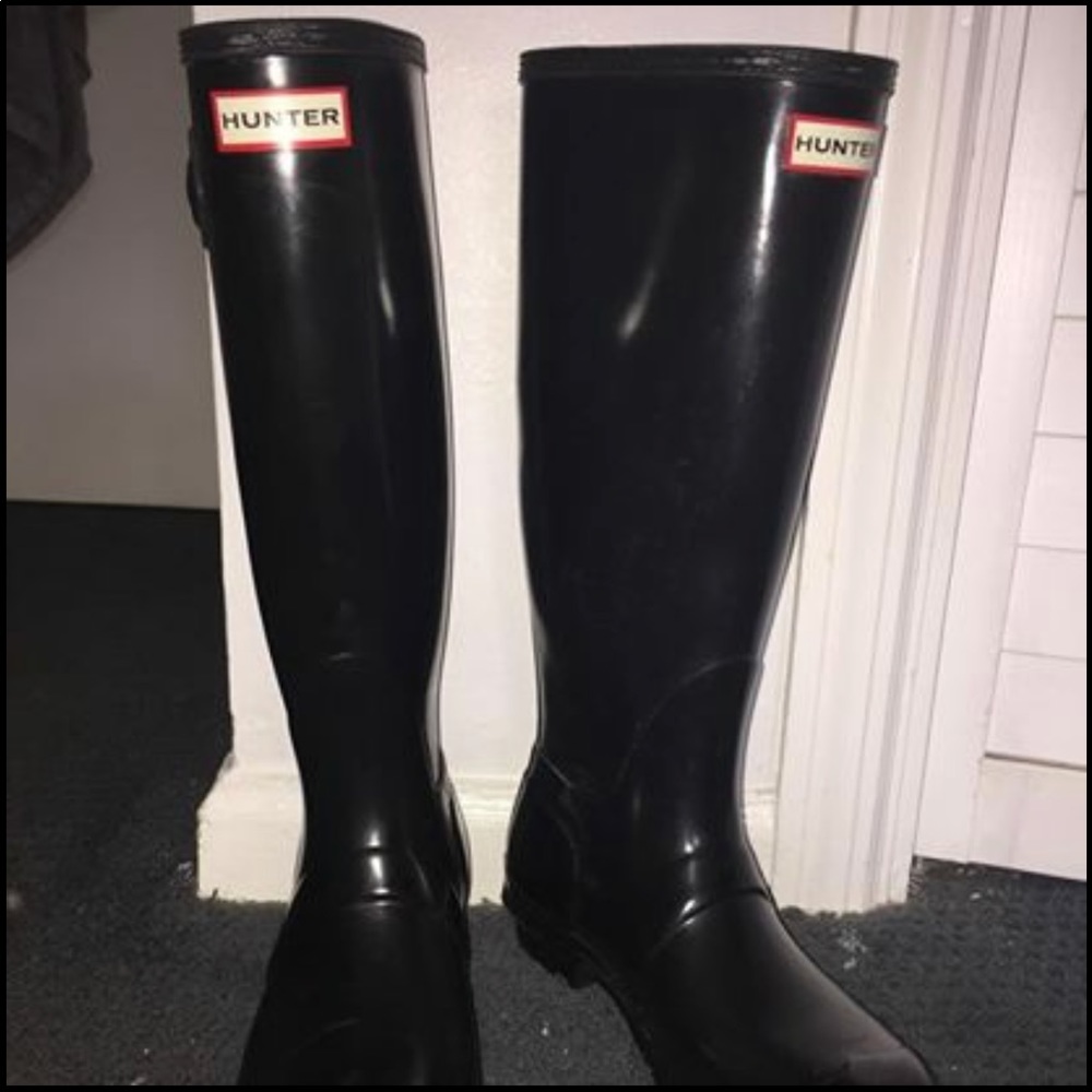 Tall, glossy black hunter rain boots.
